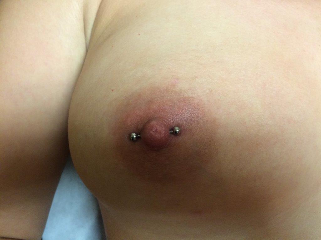 Blonde nipple piercing